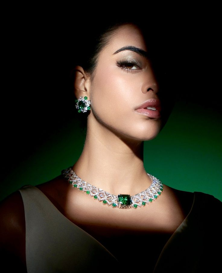 Model wearing emerald jewellery